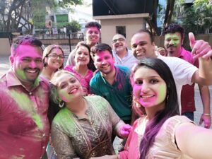 People pose for picture while celebrating Holi